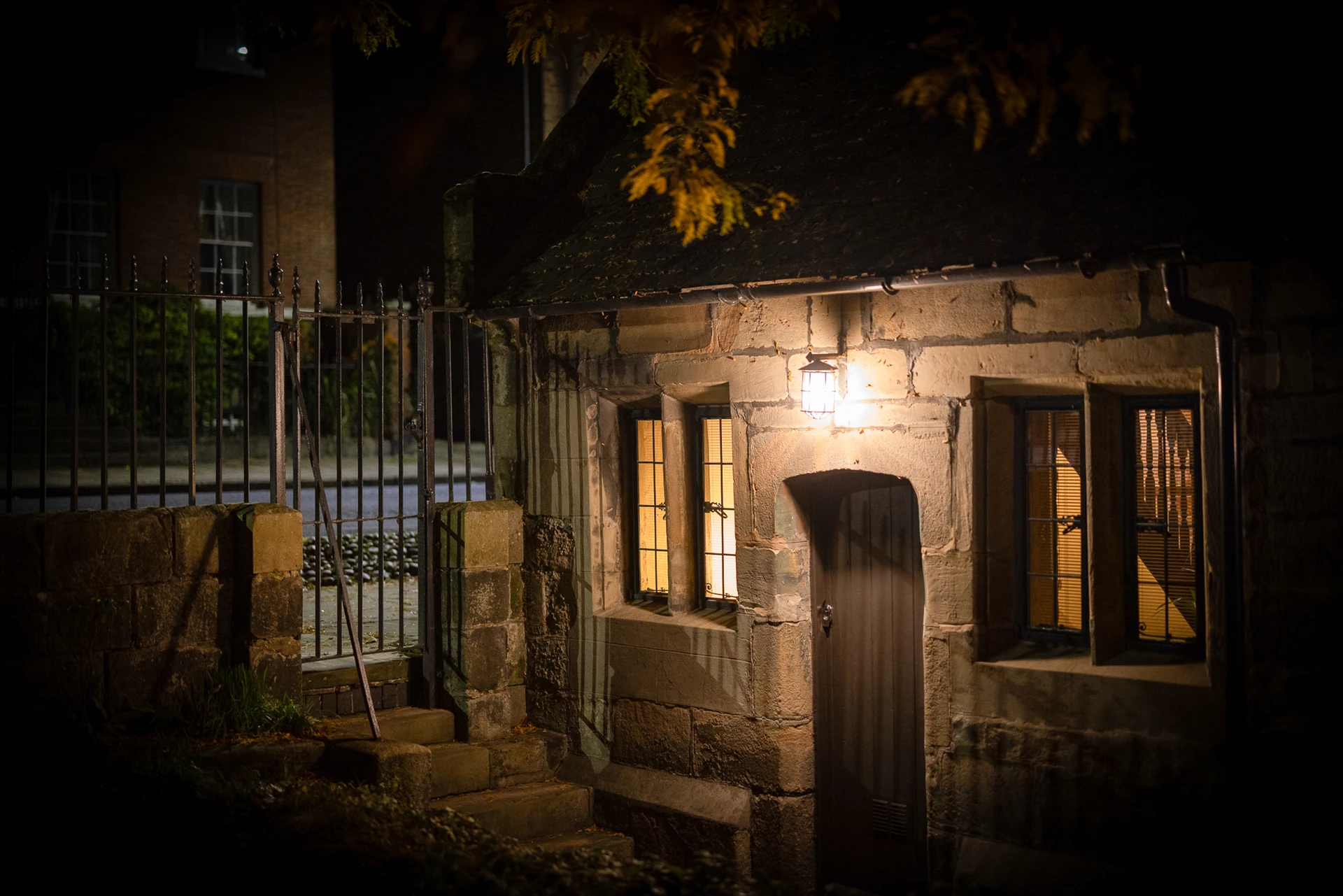 Cottage exterior illuminated at dusk at 42 Church Street