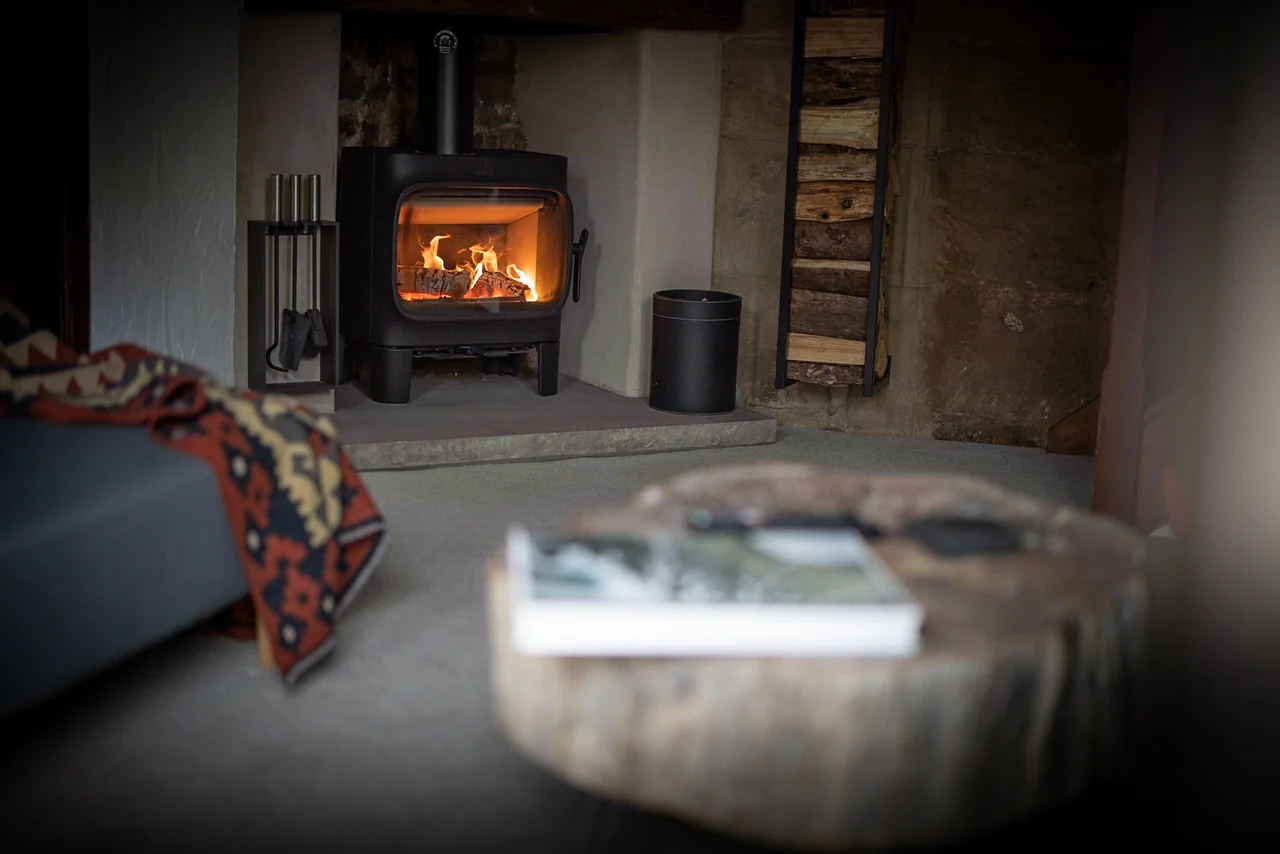 Sofa beside the glowing stove at 46 Church Street
