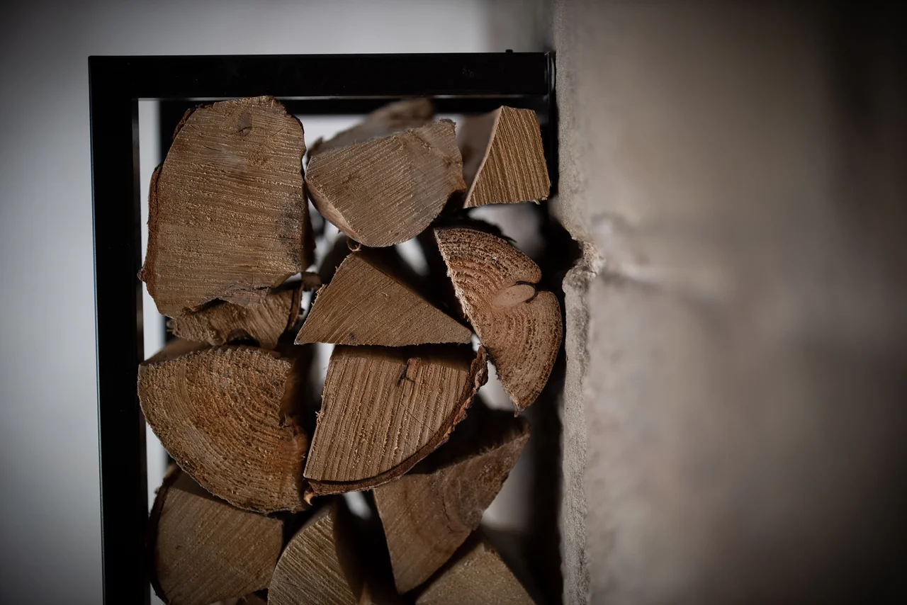 Logs stacked beside the fireplace at 46 Church Street