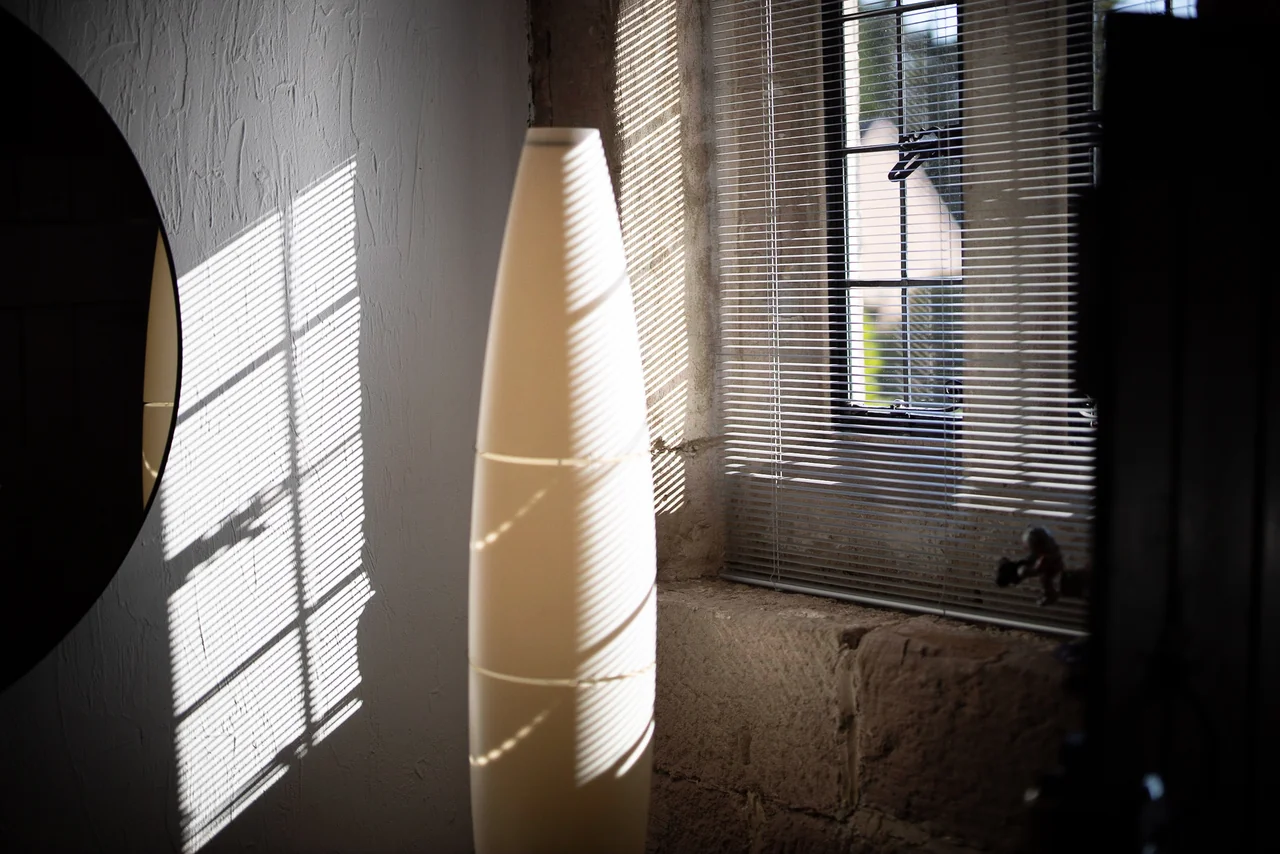 Sunlight through blinds beside a floor lamp at 46 Church Street