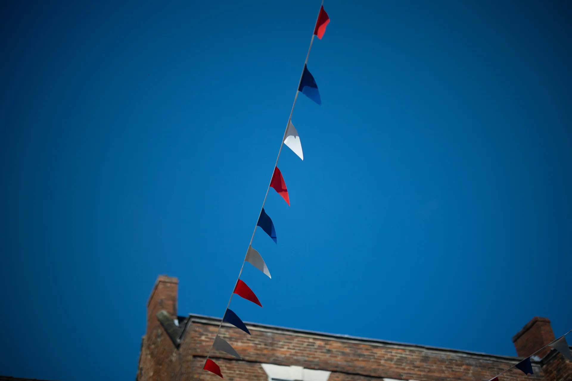 Red white and blue bunting against a blue sky
