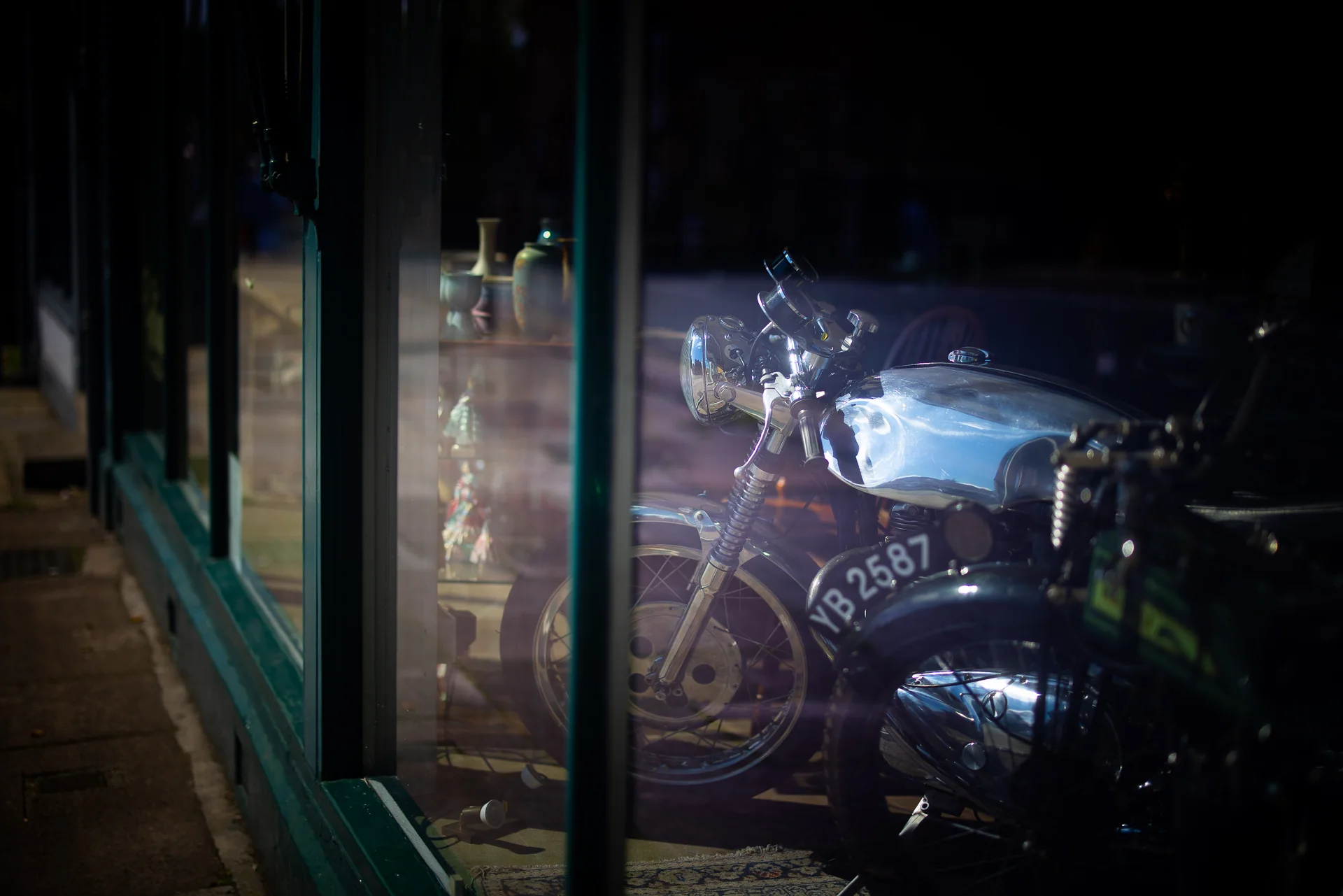 Vintage motorcycles displayed in an Ashbourne shop window
