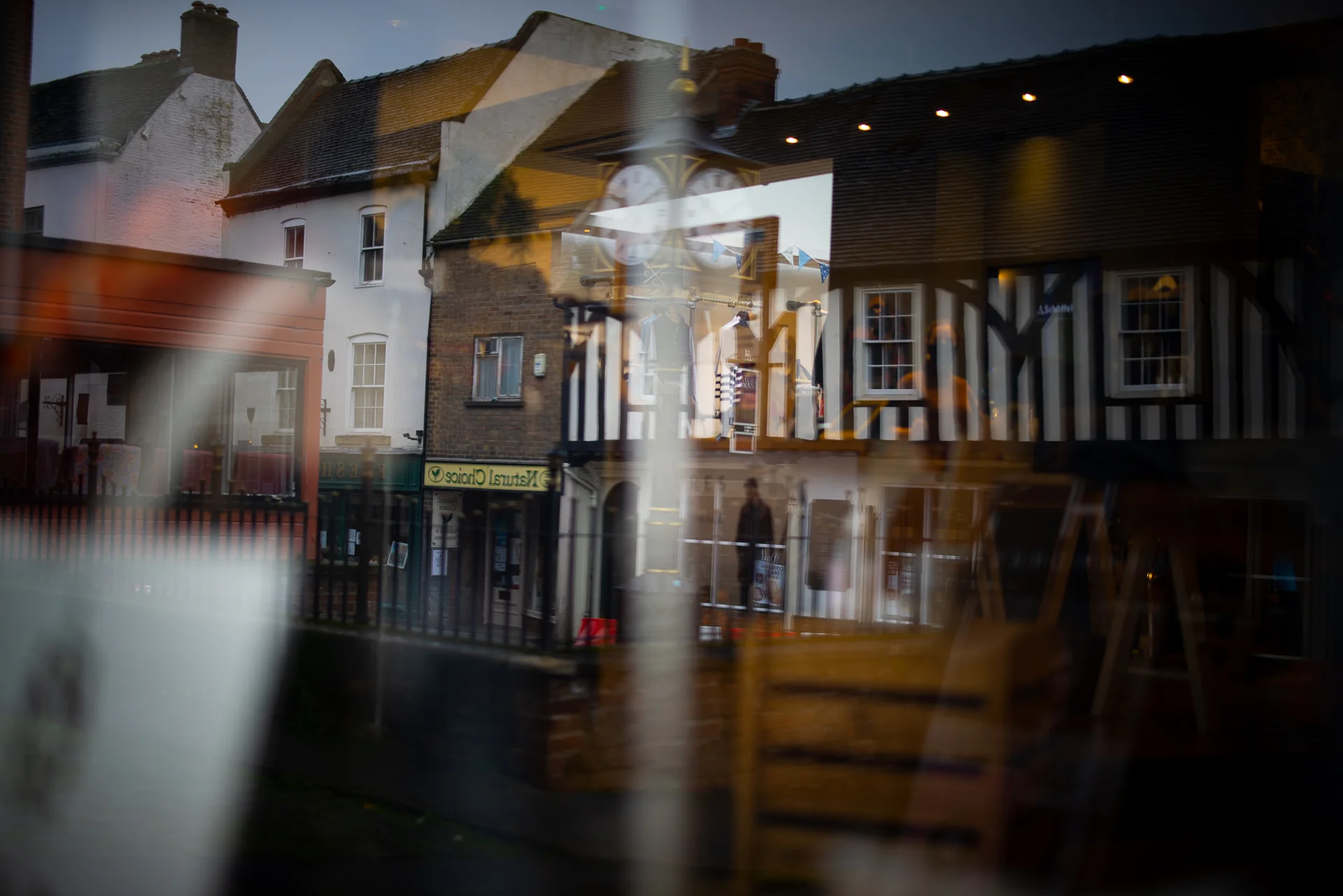 Ashbourne buildings and town clock reflected in a shop window