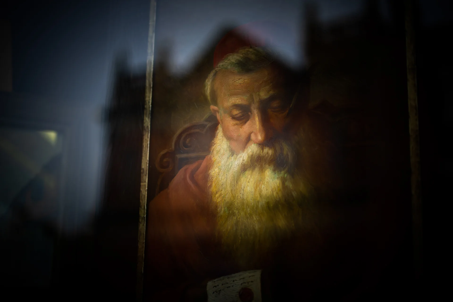 Painted portrait displayed behind an antiques shop window